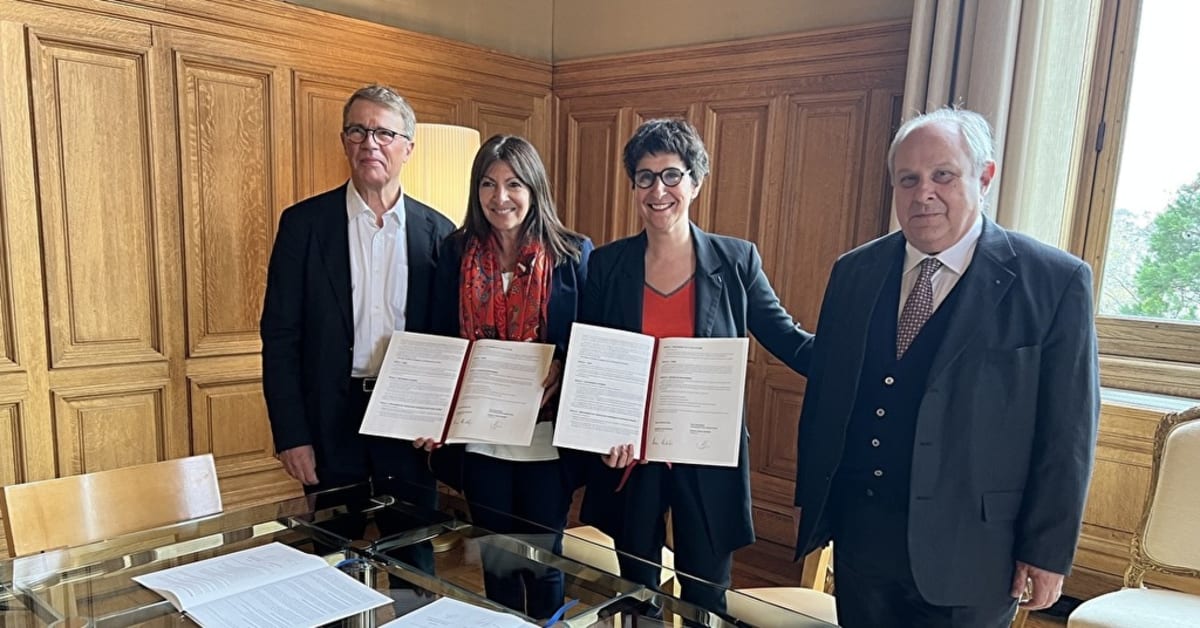 Elderly person and young student sitting together in conversation in shared living space