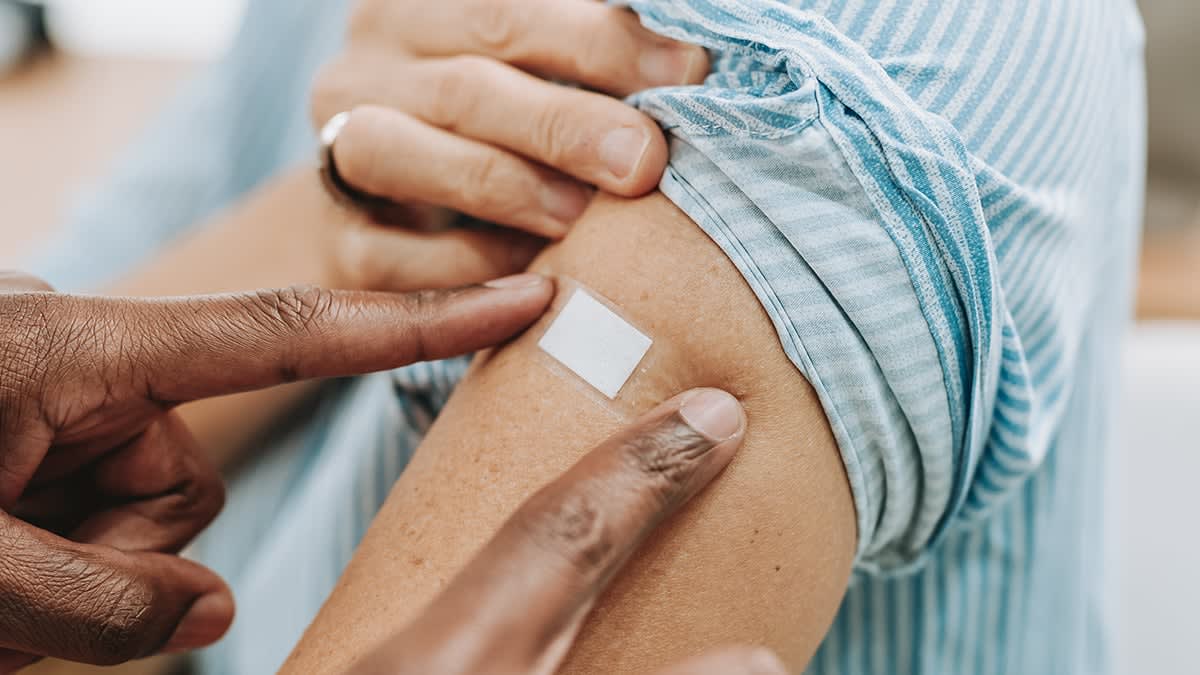 Medical professional preparing mRNA vaccine dose in clinical setting for flu prevention