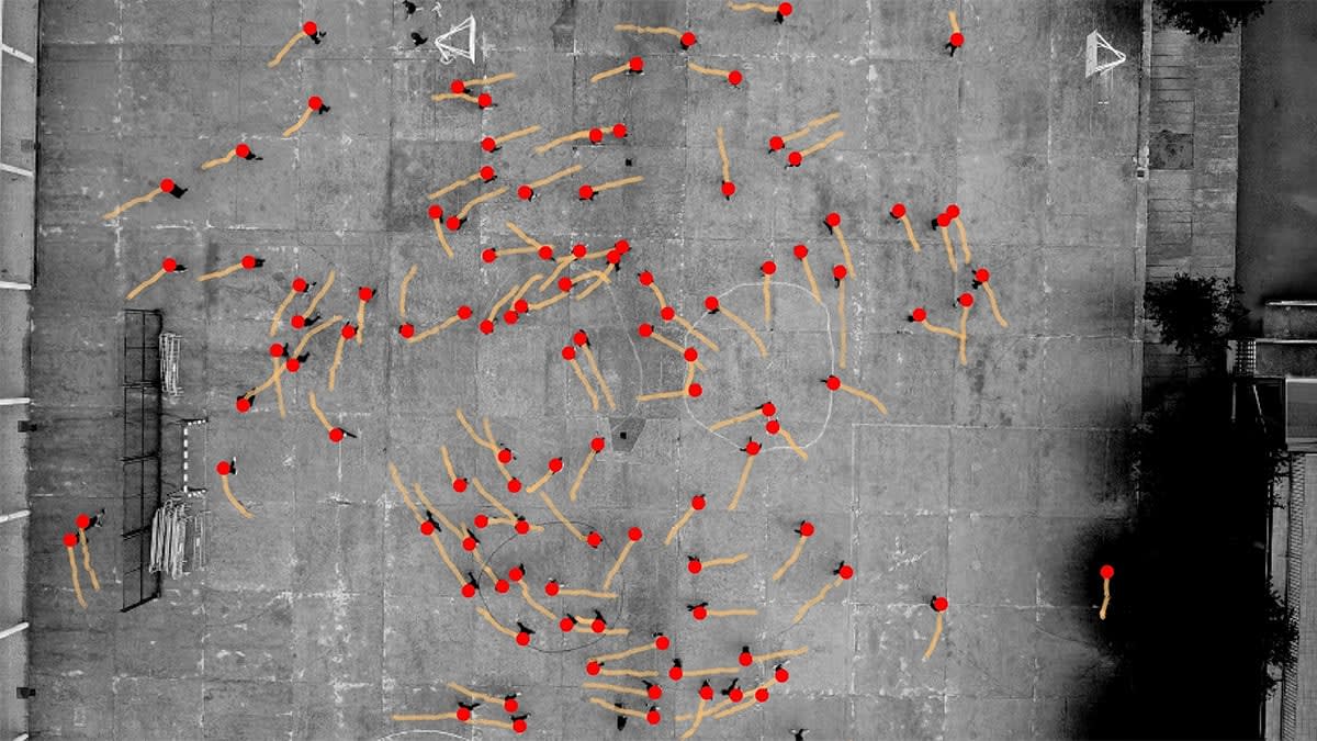 Overhead view of experiment showing people's positions as red dots with orange movement trails