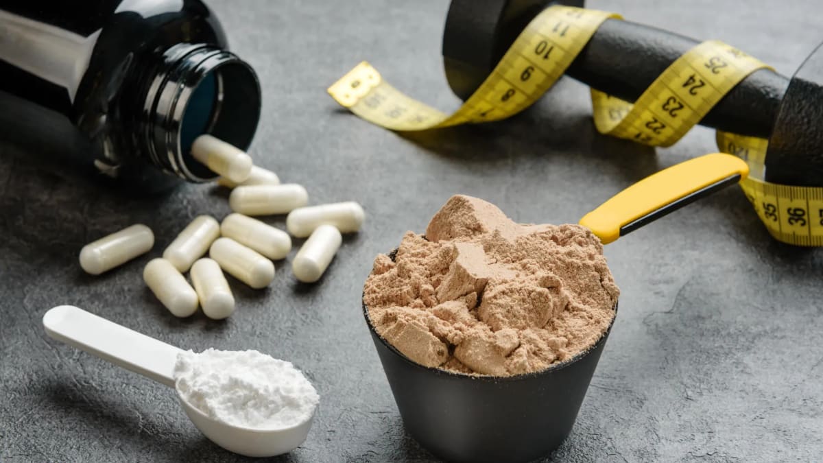 Creatine supplement powder and scoop with microscope in medical research laboratory background
