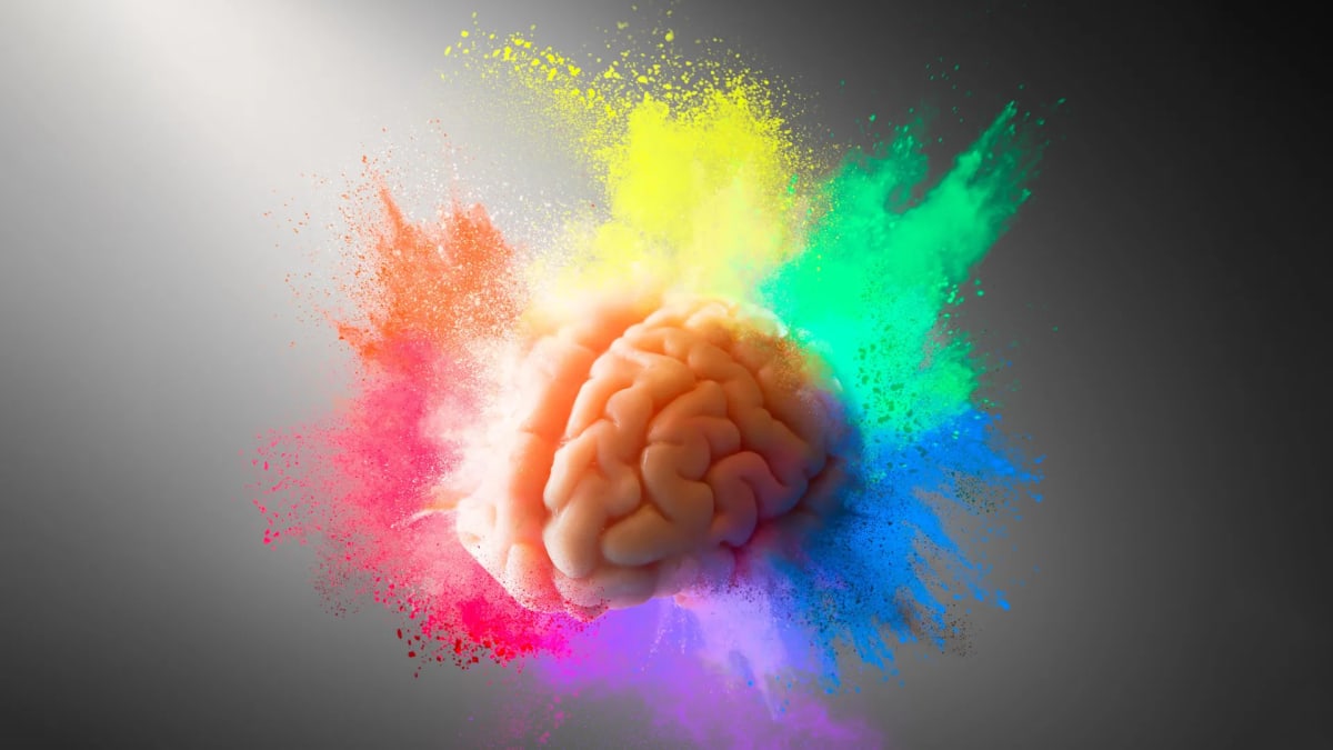 Child engaged in creative art activity, painting colorful abstract designs with focused expression
