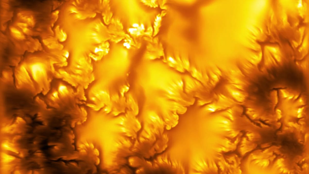 High resolution image of the Sun's surface showing swirling plasma vortices along solar granules