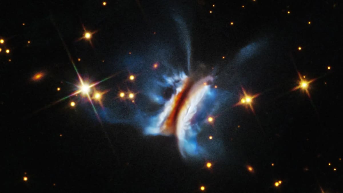 Hubble telescope image showing enormous lopsided disk of gas and dust surrounding young star