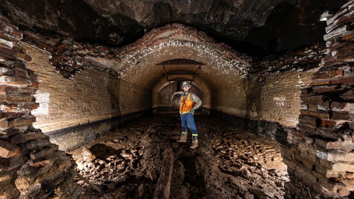 Mining engineer Jason Connot standing in underground tunnel 1100 feet below surface at research facility