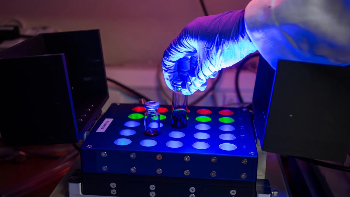 LED lamp illuminating laboratory glassware during light-powered chemical reaction at Cambridge University