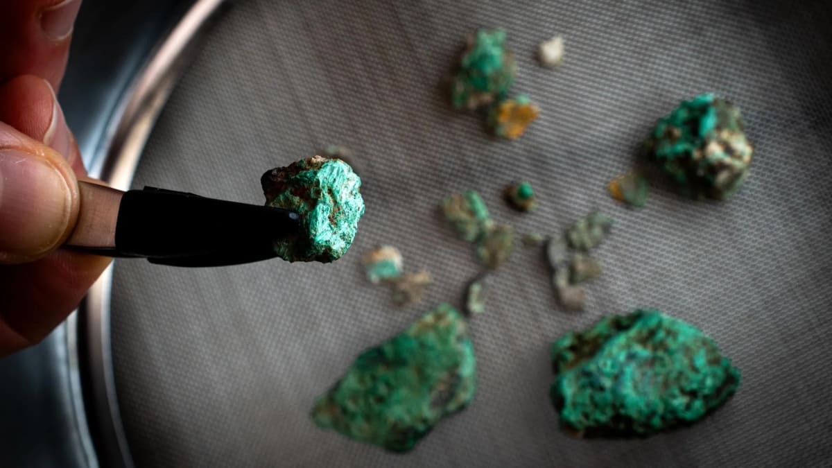 Green malachite mineral fragments recovered from ancient hearths in Pyrenees mountain cave excavation site