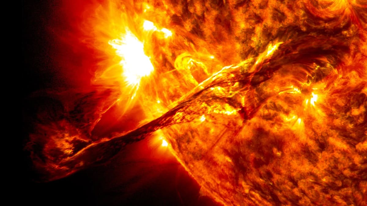 Orange glowing Sun surface with dark sunspots showing magnetic activity and solar storms