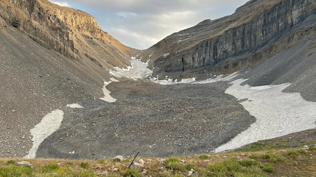 Rocky mountain slope beneath Mount Timpanogos concealing massive ice glacier underneath loose debris