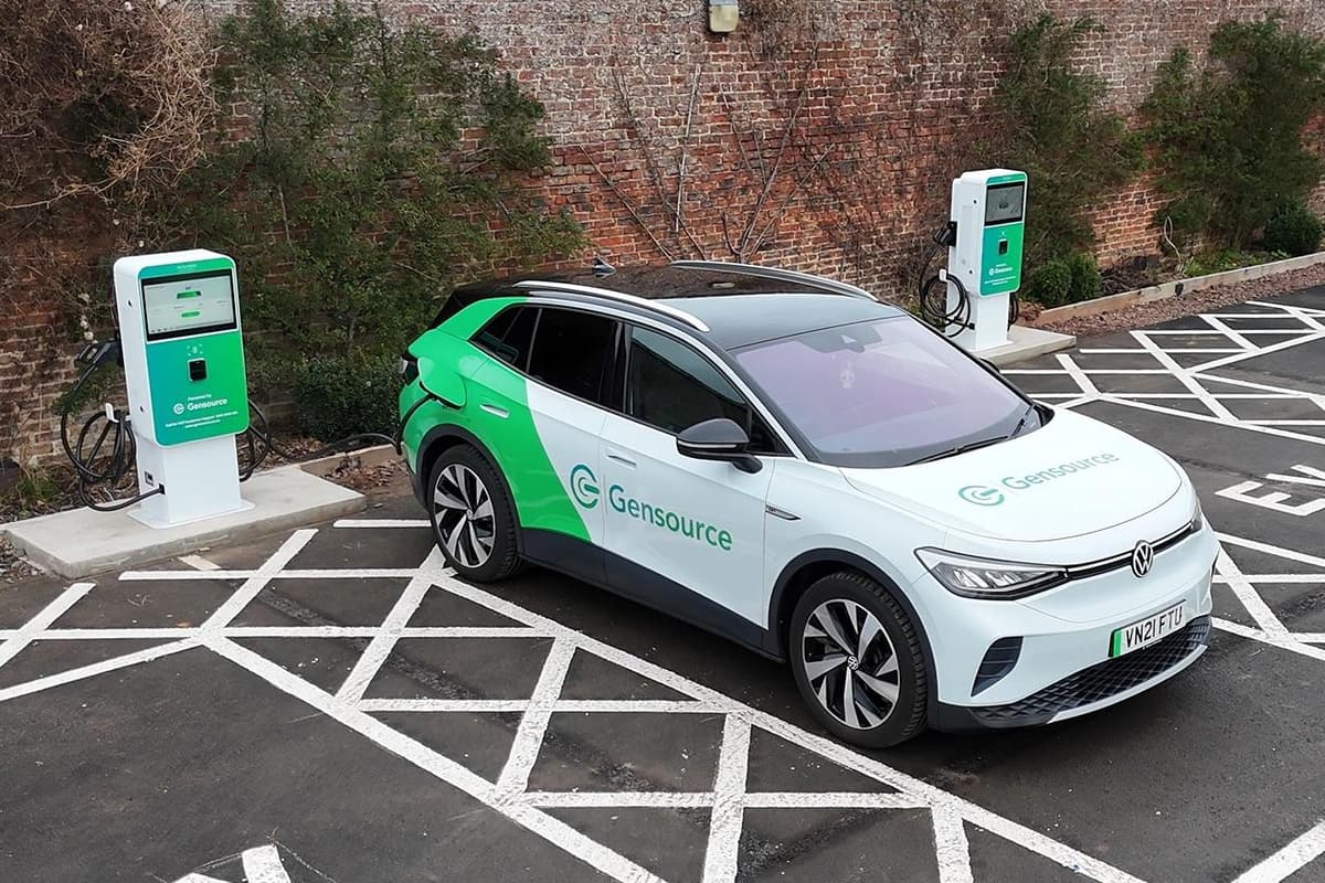 Electric vehicle charging stations at historic Scottish walled garden with solar panels visible