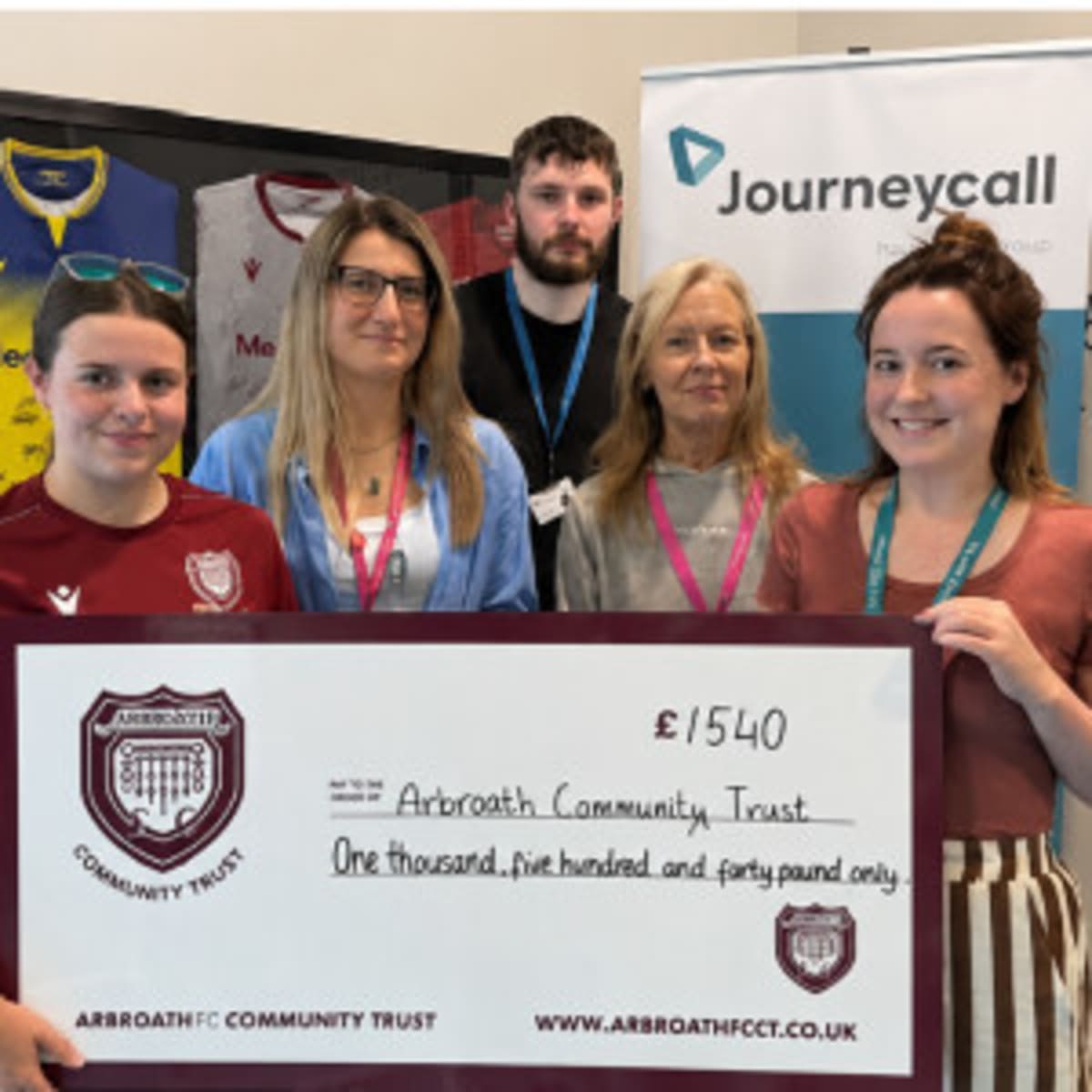 ESP Group team members presenting oversized charity check to Arbroath Community Trust representative