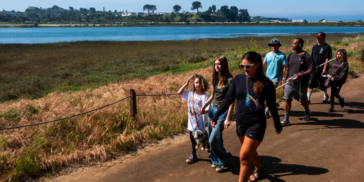 Indigenous youth conducting coastal ecosystem research and water monitoring in San Diego wetlands