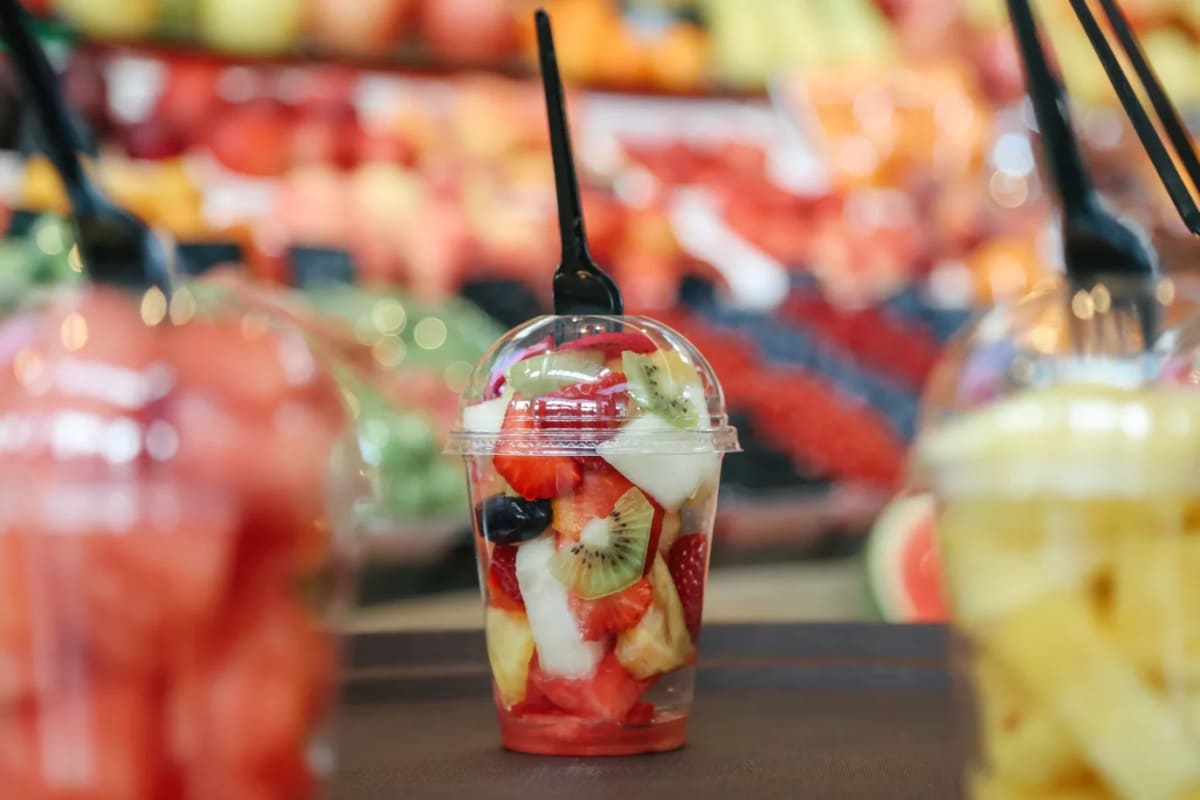 Clean Baltic Sea coastline with city skyline in background, representing municipal environmental progress