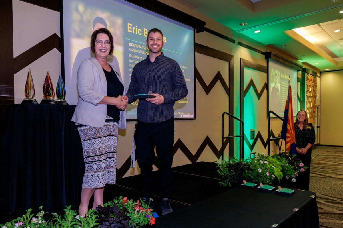 Dr. Jennifer Ritter presenting Outstanding Student Award to Eric Barnes at Yavapai College recognition ceremony