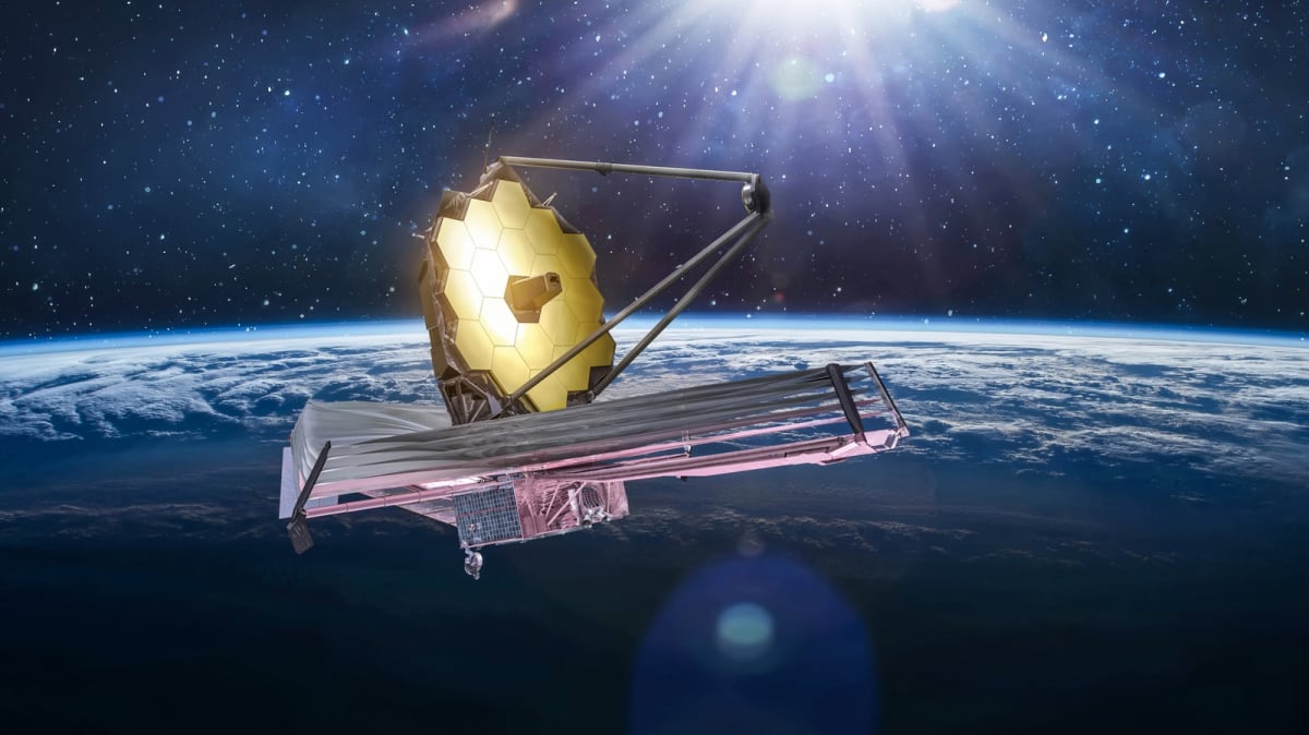 James Webb Space Telescope's golden hexagonal mirrors and massive silver sunshield in deep space