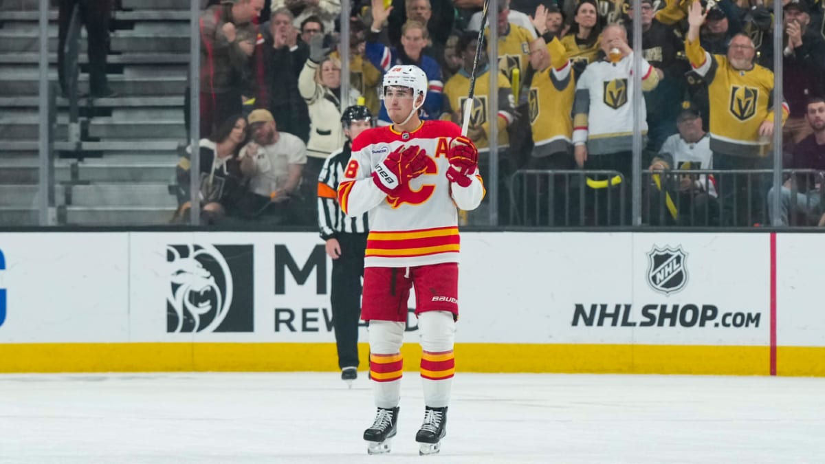 ** Hockey players in different team jerseys embracing after practice on ice rink