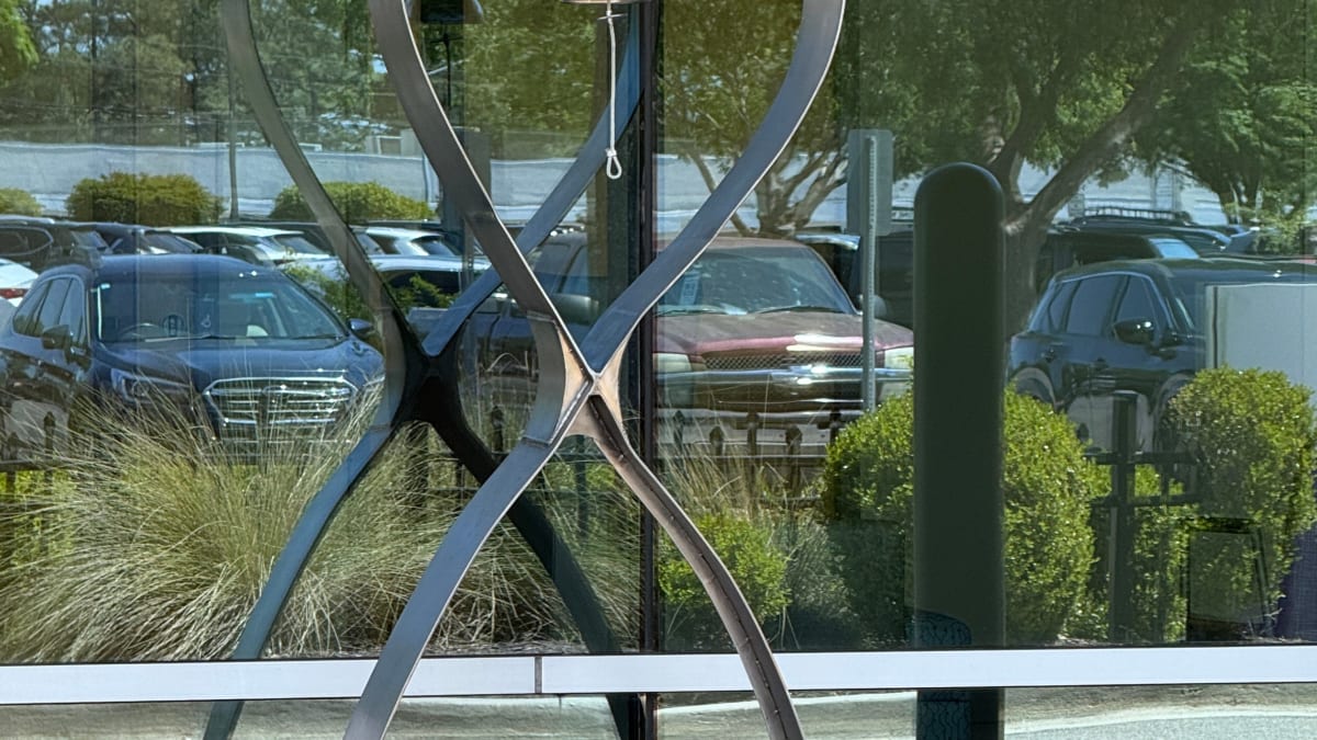 Custom designed cancer survivor bell outside Novant Health Zimmer Cancer Institute entrance in Wilmington