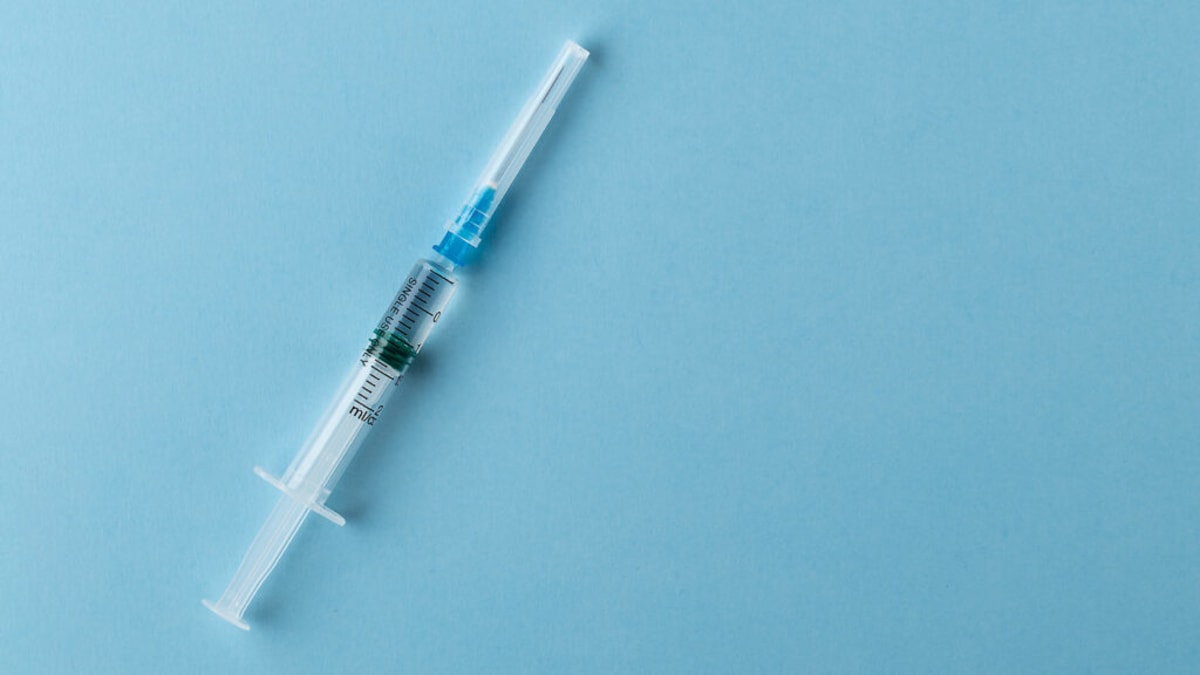 Scientists in laboratory working with mRNA vaccine vials for cancer treatment research