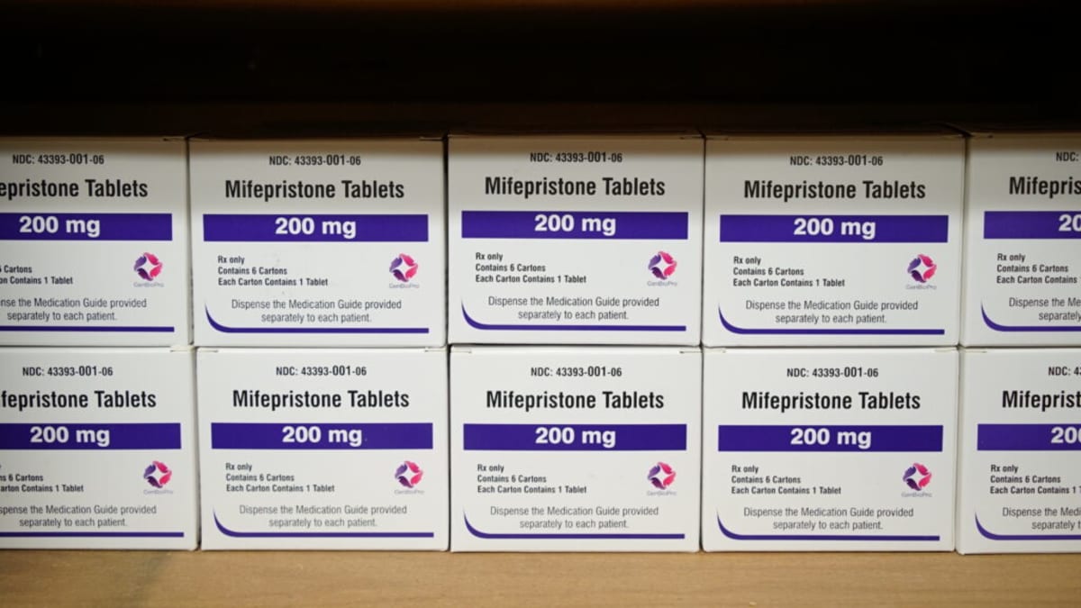 Boxes of mifepristone medication on table in medical setting