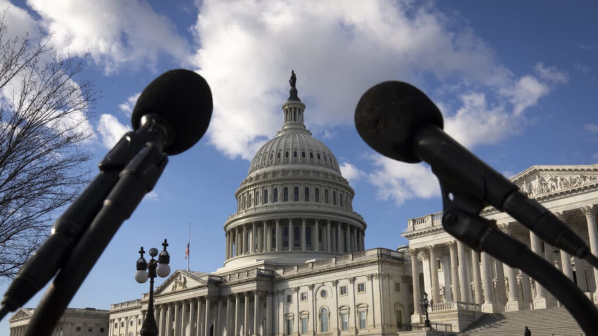 Diverse group of scientists and advocates meeting around conference table discussing autism research priorities