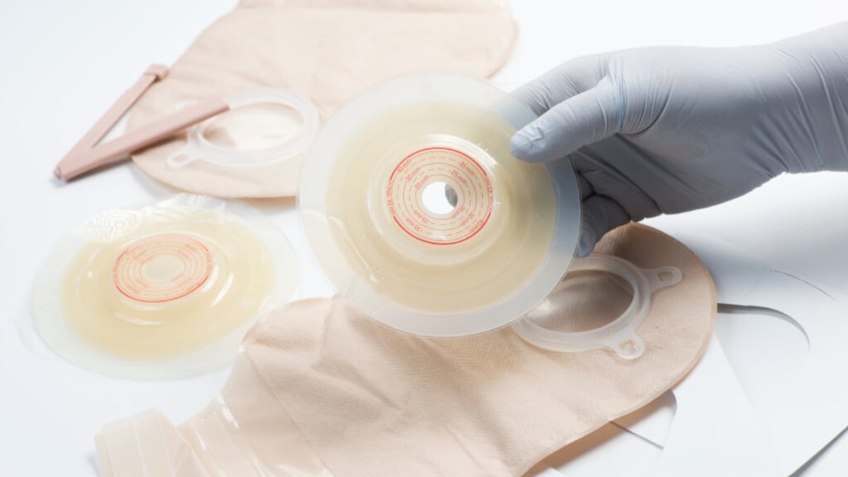 Medical professional reviewing patient care documents in hospital setting with compassionate focus