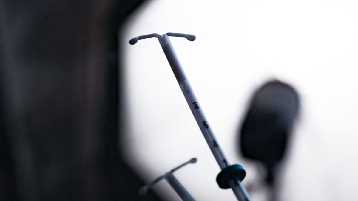 Female doctor consulting with patient in modern medical office, demonstrating patient-centered healthcare approach