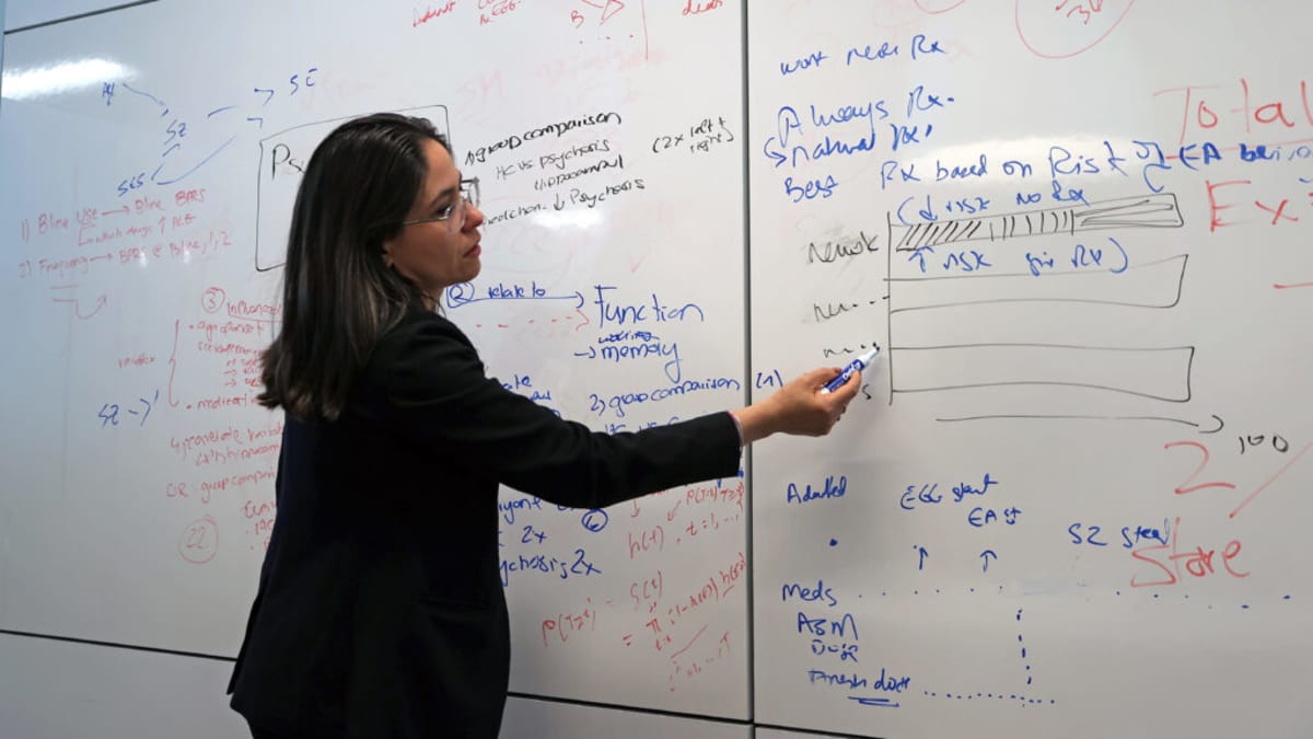 Medical researcher examining brain scan imagery with artificial intelligence technology for Alzheimer's detection