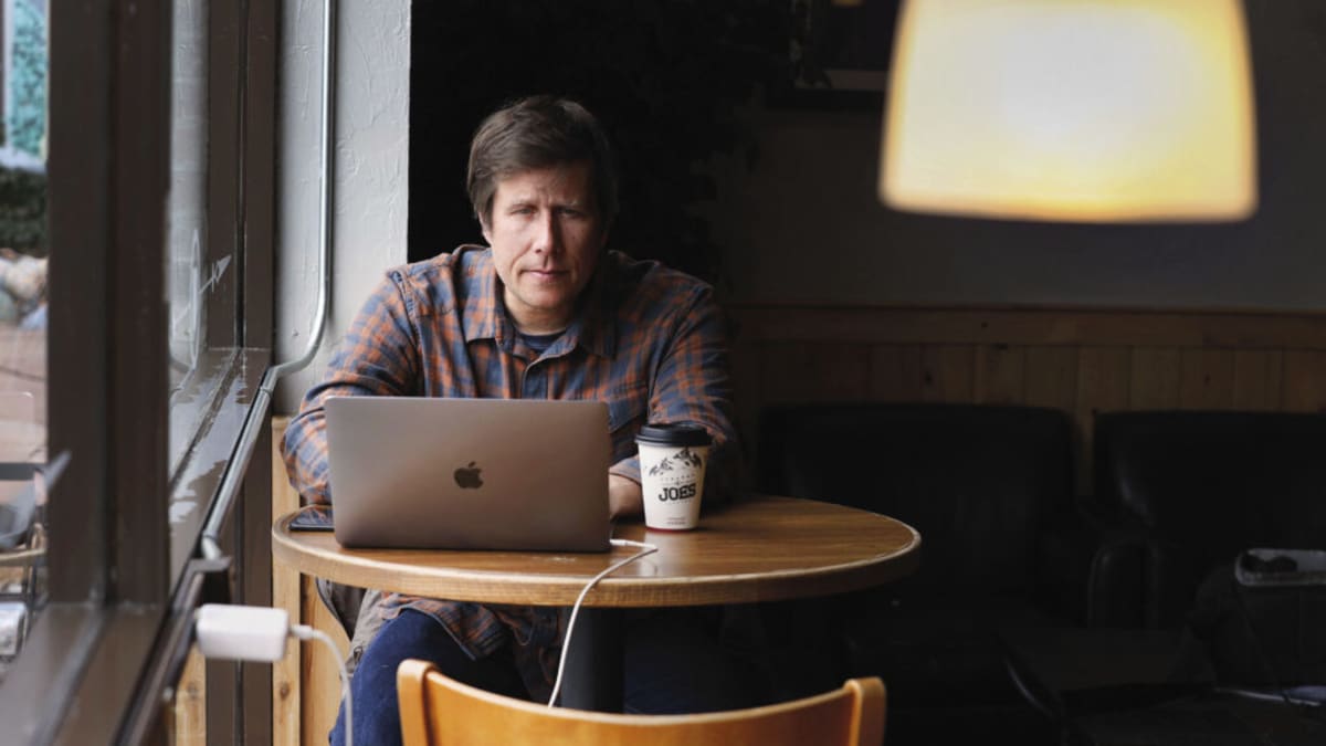 Teacher explaining genetics concepts to diverse group of high school students in classroom