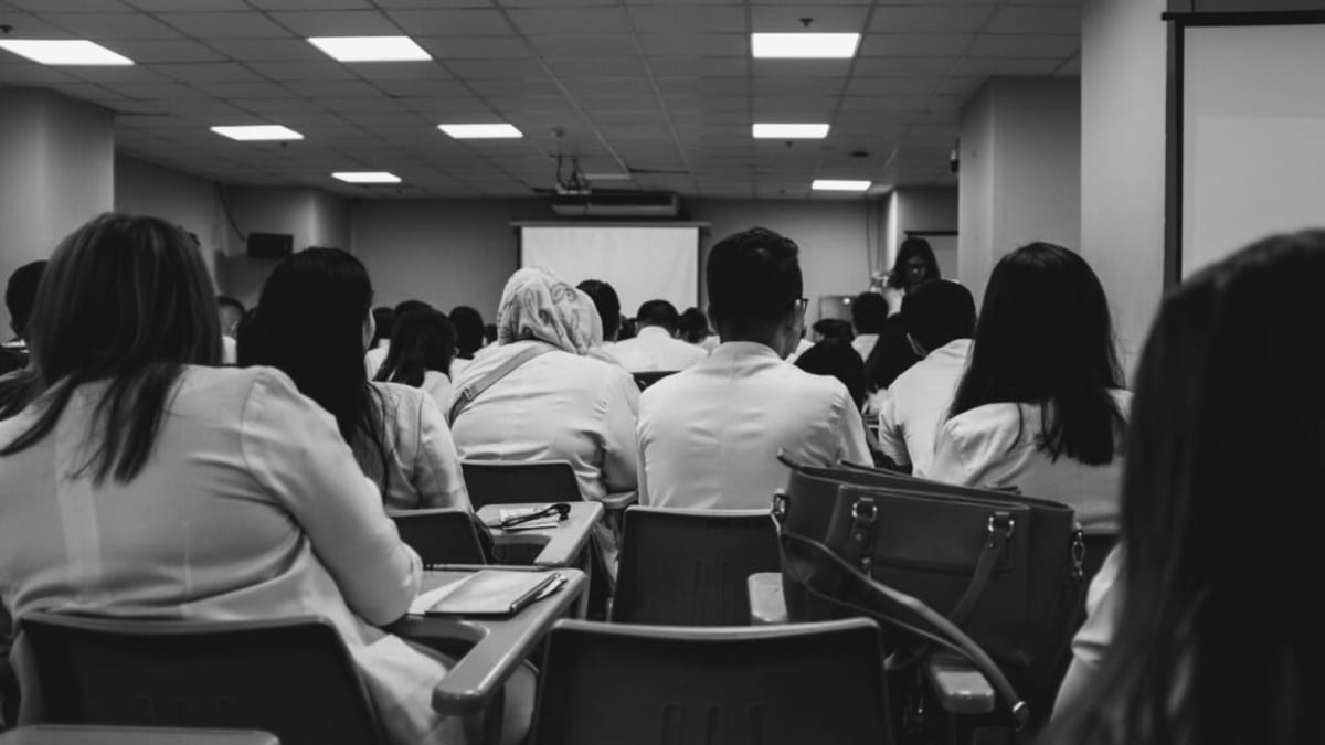 Dawn Zuidgeest-Craft with her husband at her white coat ceremony celebrating medical school