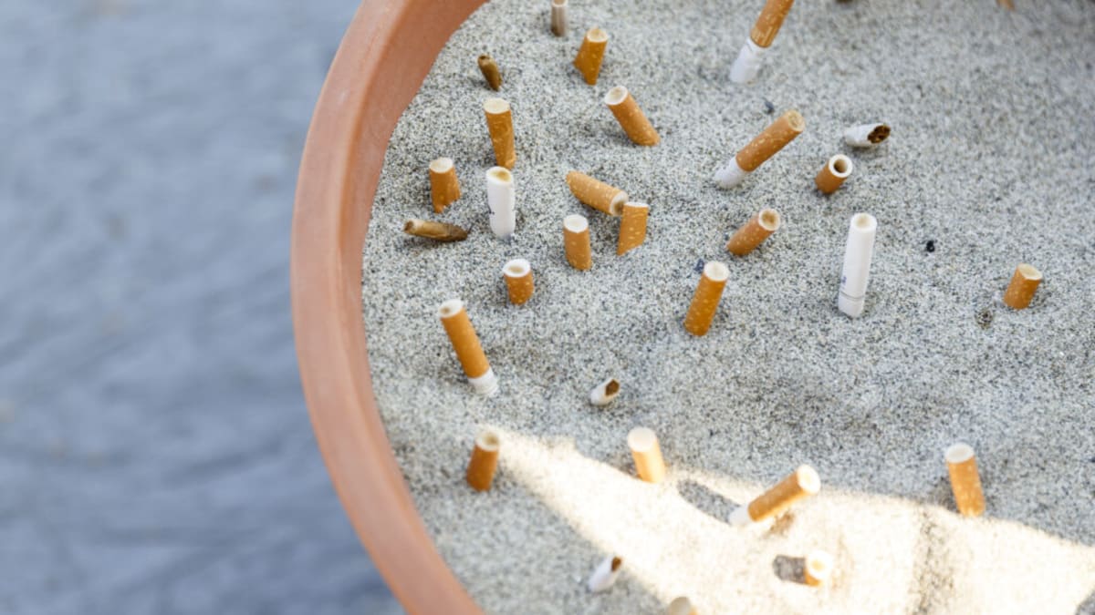 Doctor having supportive conversation with patient about quitting smoking in medical office