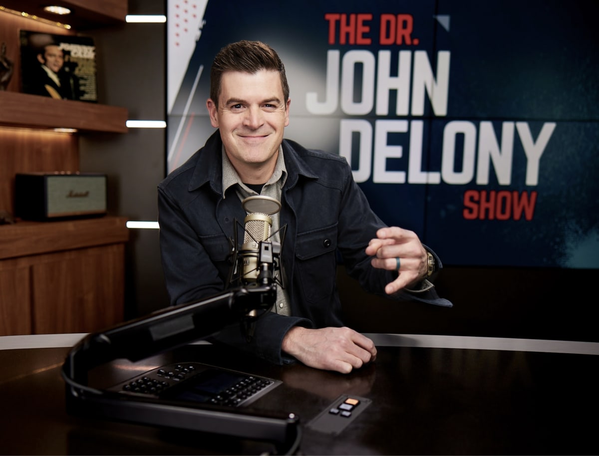 Dr. John Delony speaking into microphone during his mental health advice YouTube show