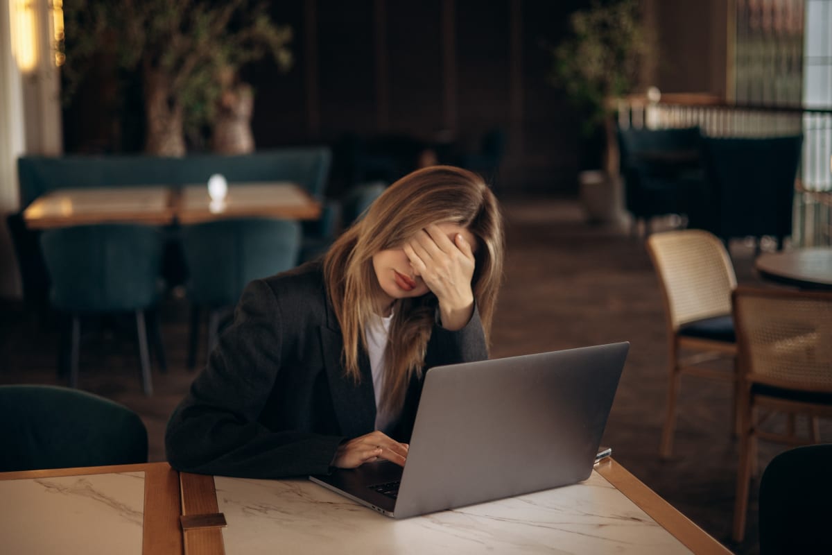 Professional woman smiling confidently in modern office space representing mental health recovery and business success