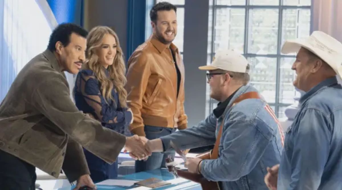 Christian Brown holds his newborn son Isaiah in hospital room after heart surgery