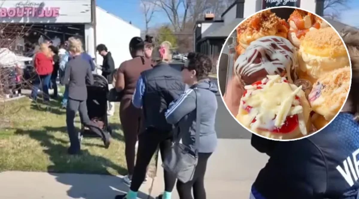 Colorful cupcakes displayed at Sweet 220 family bakery in Detroit with customers waiting