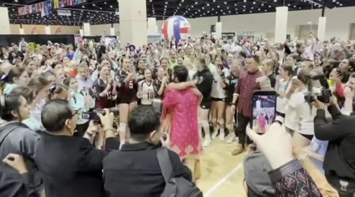 Volleyball team dancing and celebrating with bride and groom in wedding attire during tornado shelter