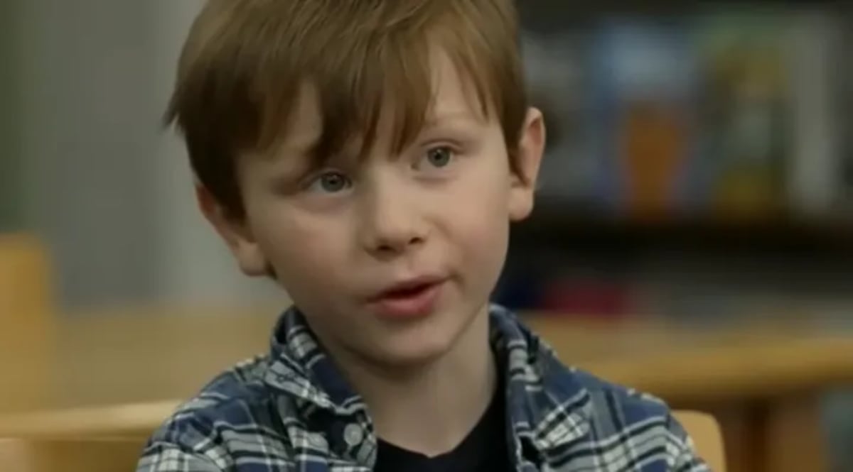 Young deaf student Ben O'Reilly smiling with classmates at Campton Elementary School in New Hampshire