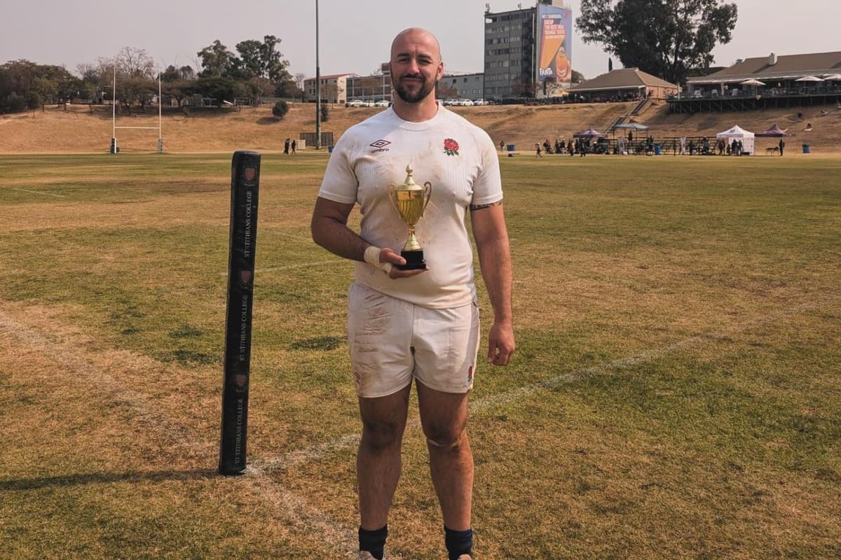 Taylor Morris in England rugby kit holding ball during training session