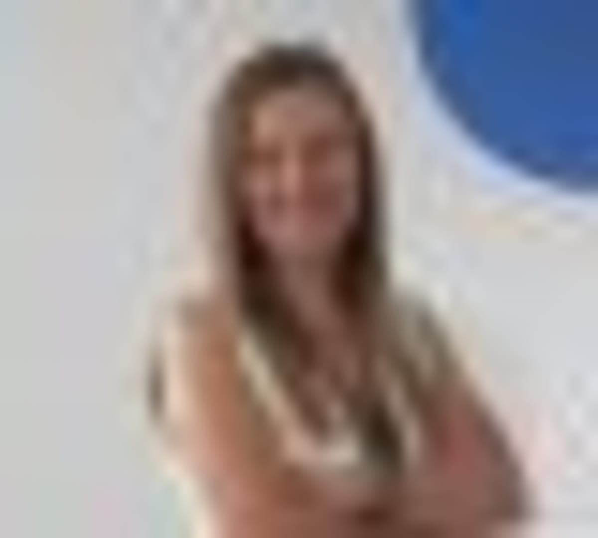 Elderly person at home with subtle AI monitoring sensors providing safety and connection