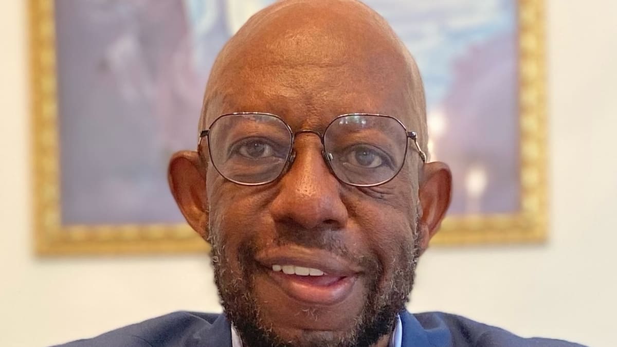 DeVance Walker Jr. smiling in professional attire, champion of minority business development