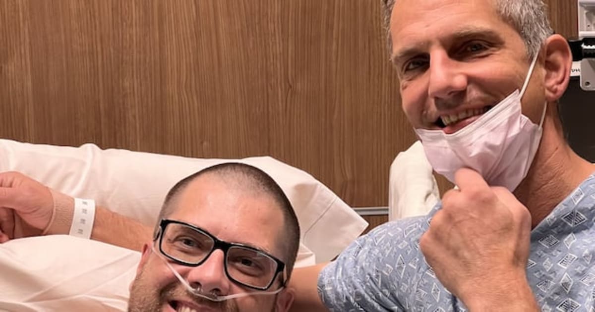 ** Brad Bywater and Chris Runkel smiling together moments after successful kidney transplant surgery
