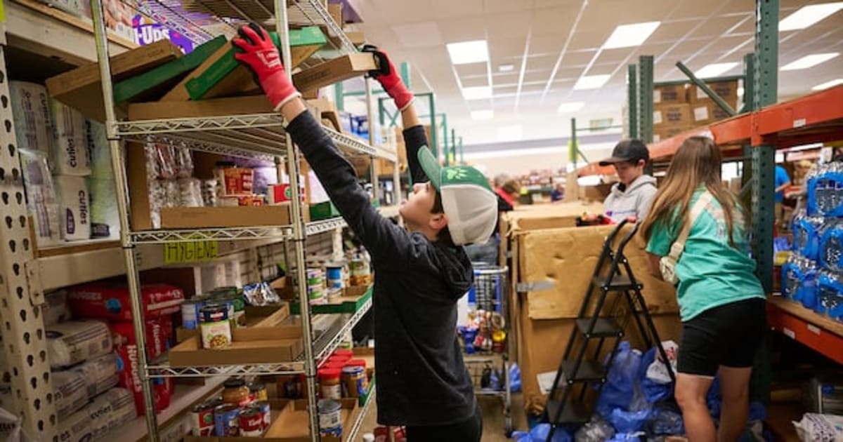 Volunteers unloading boxes of donated food from truck at community food pantry