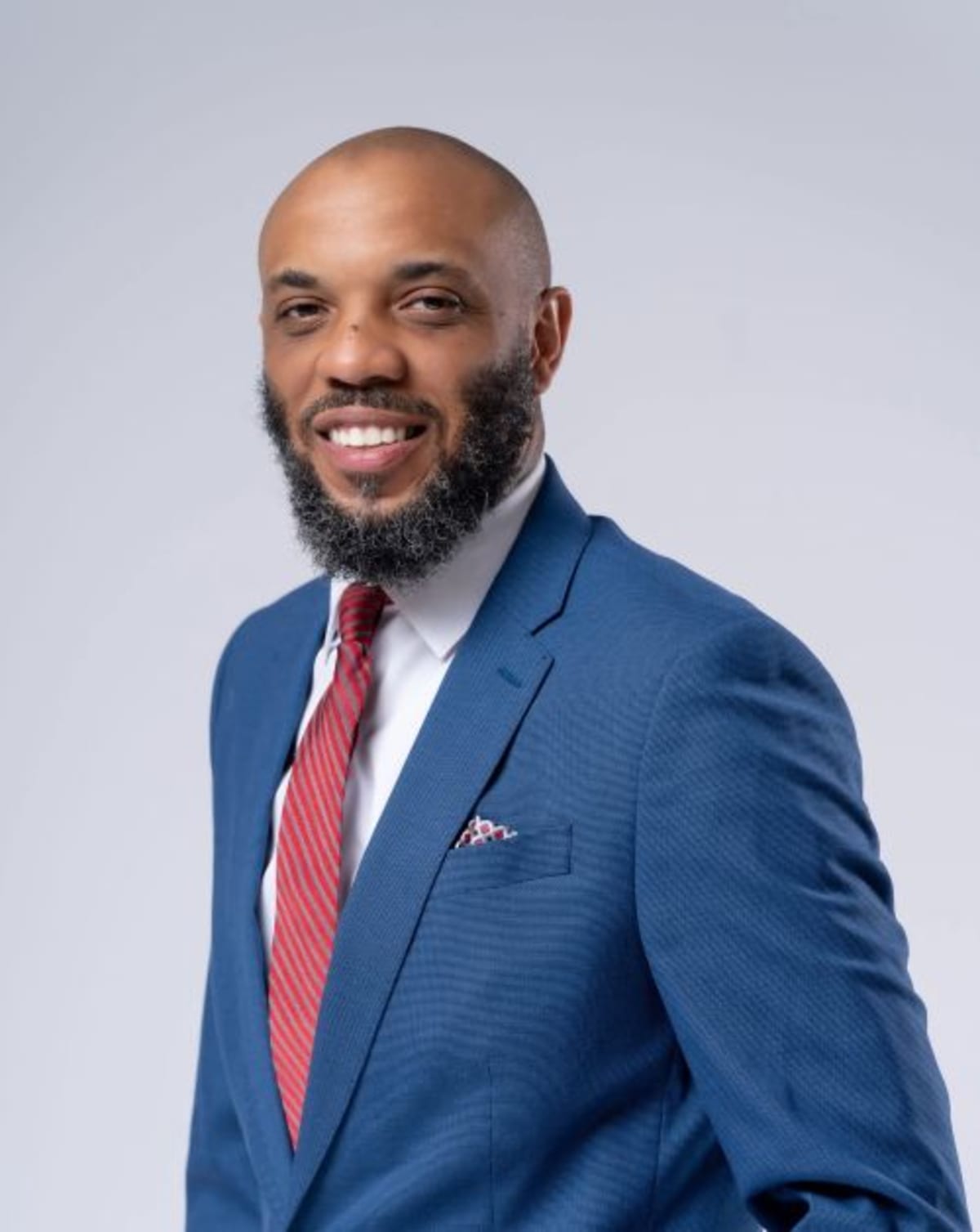 Jermaine J. Williams, peer recovery specialist, smiling confidently while supporting others in their healing journey