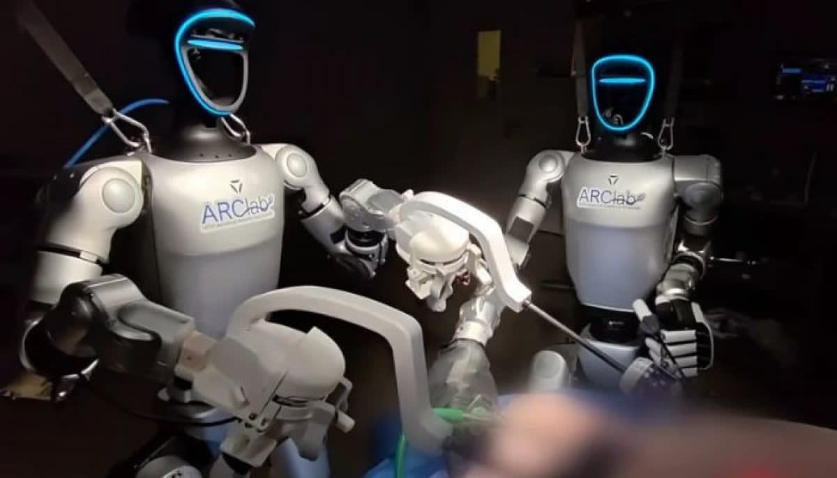 Humanoid robot Surgie performing surgical procedure alongside medical team in operating room