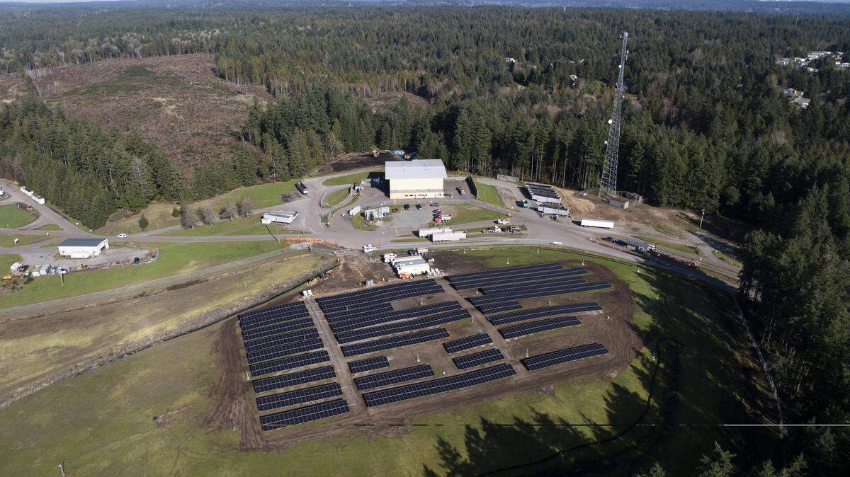 Solar panel array installed across grassy former landfill site in Purdy, Washington