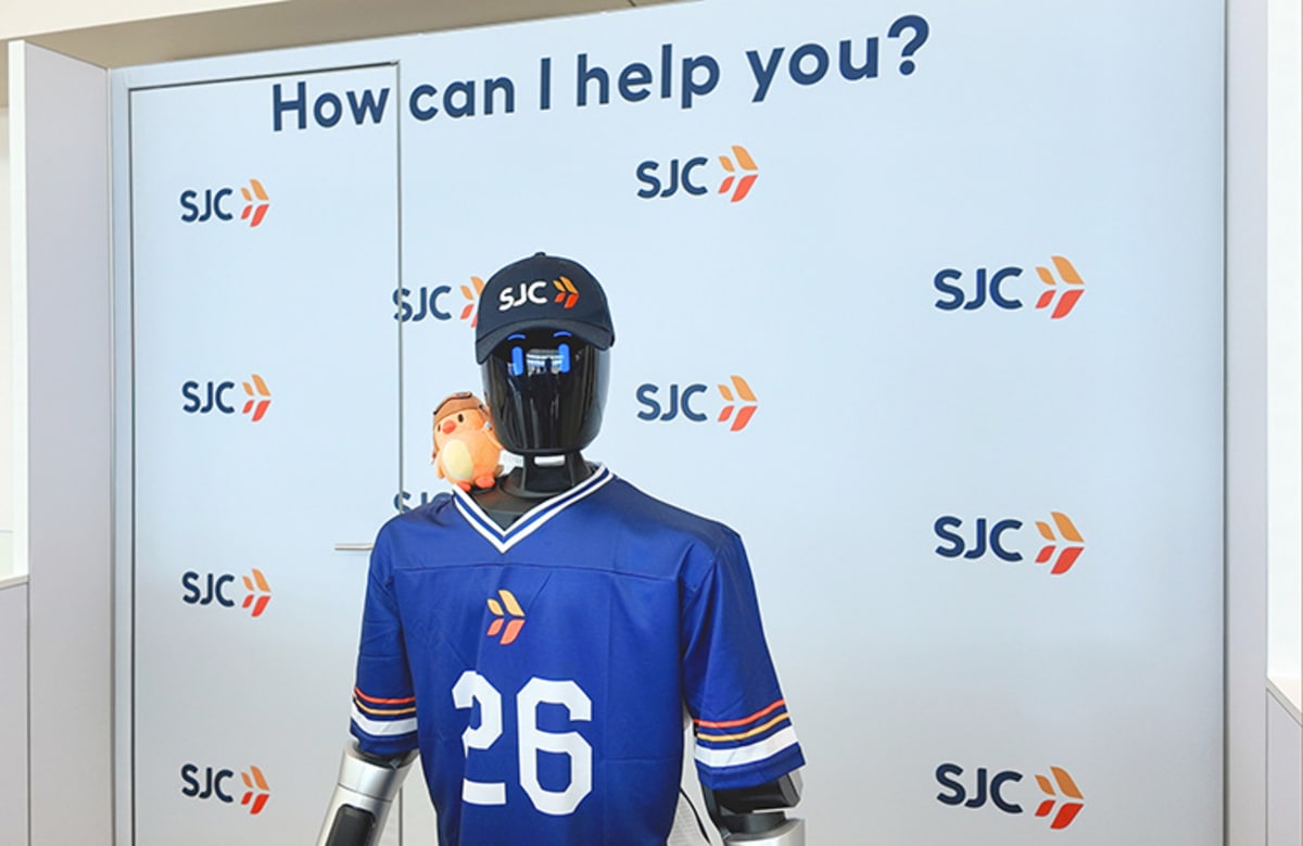 Humanoid robot José standing at airport terminal greeting and assisting international travelers