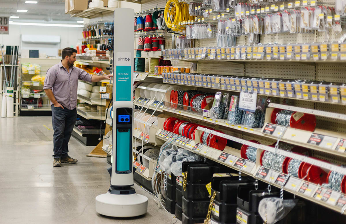 Tally autonomous robot scanning retail store shelves while shoppers browse nearby aisles