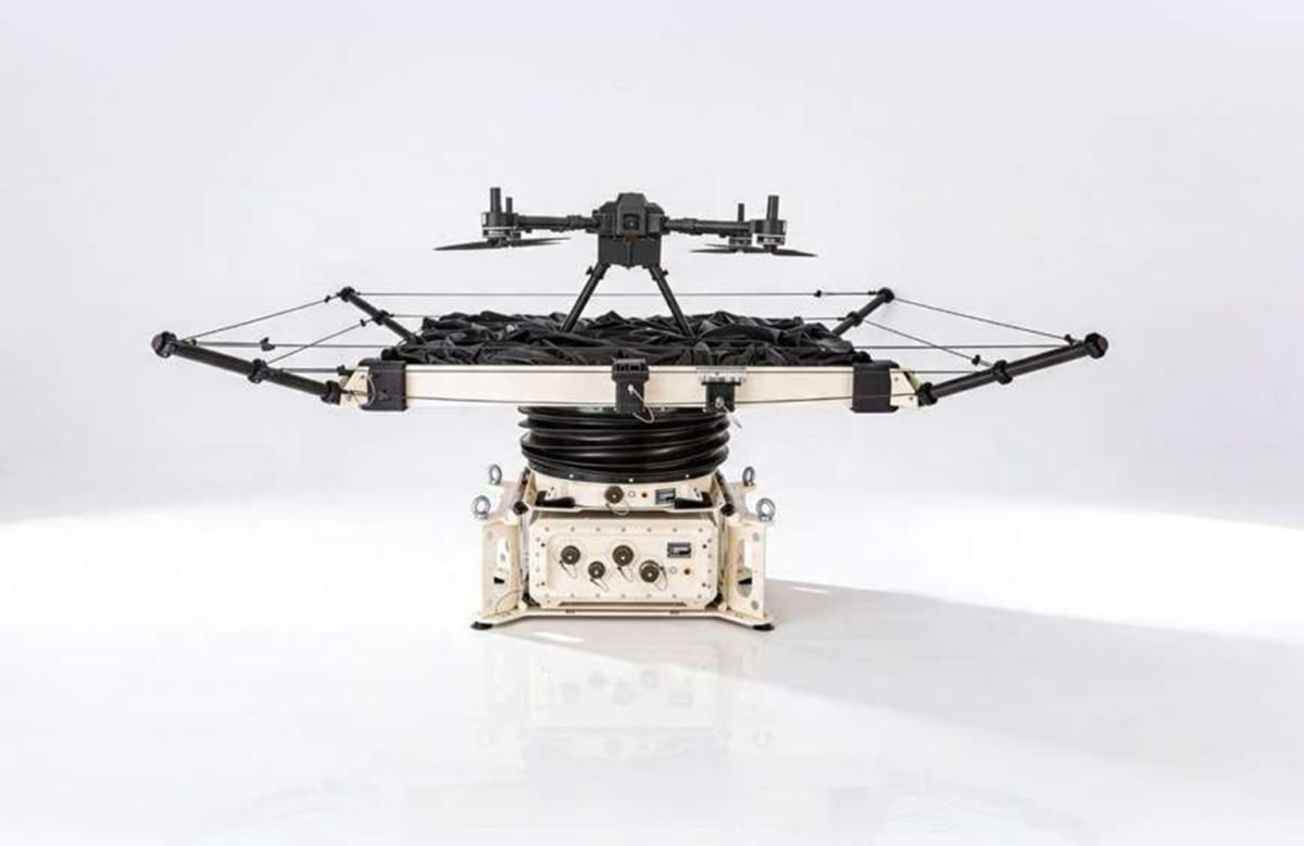 Drone landing on stabilized platform aboard small vessel in open ocean waters