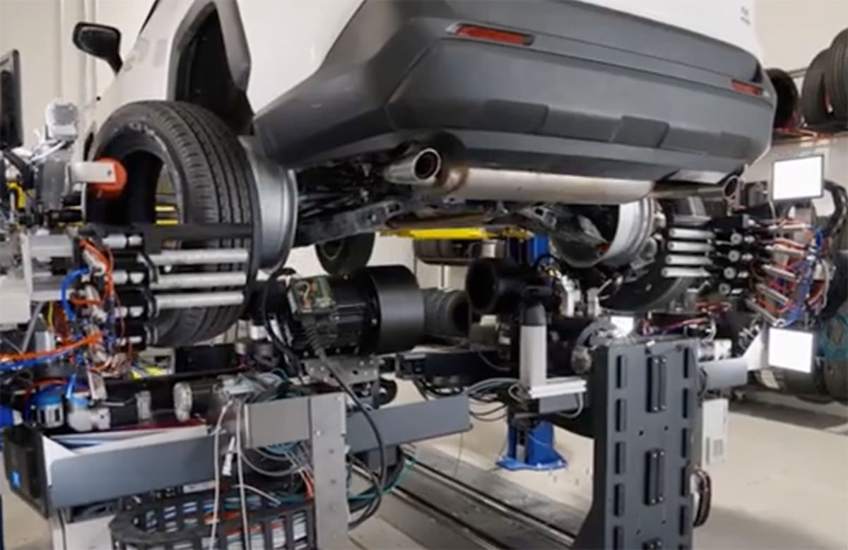 Robotic SmartBay system changing vehicle tires from underneath while wheels remain attached