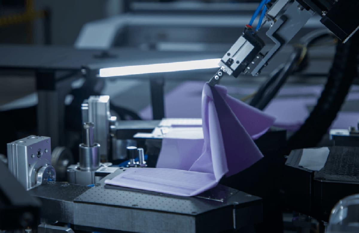 Robotic assembly system using precision adhesive bonding technology to manufacture garments automatically
