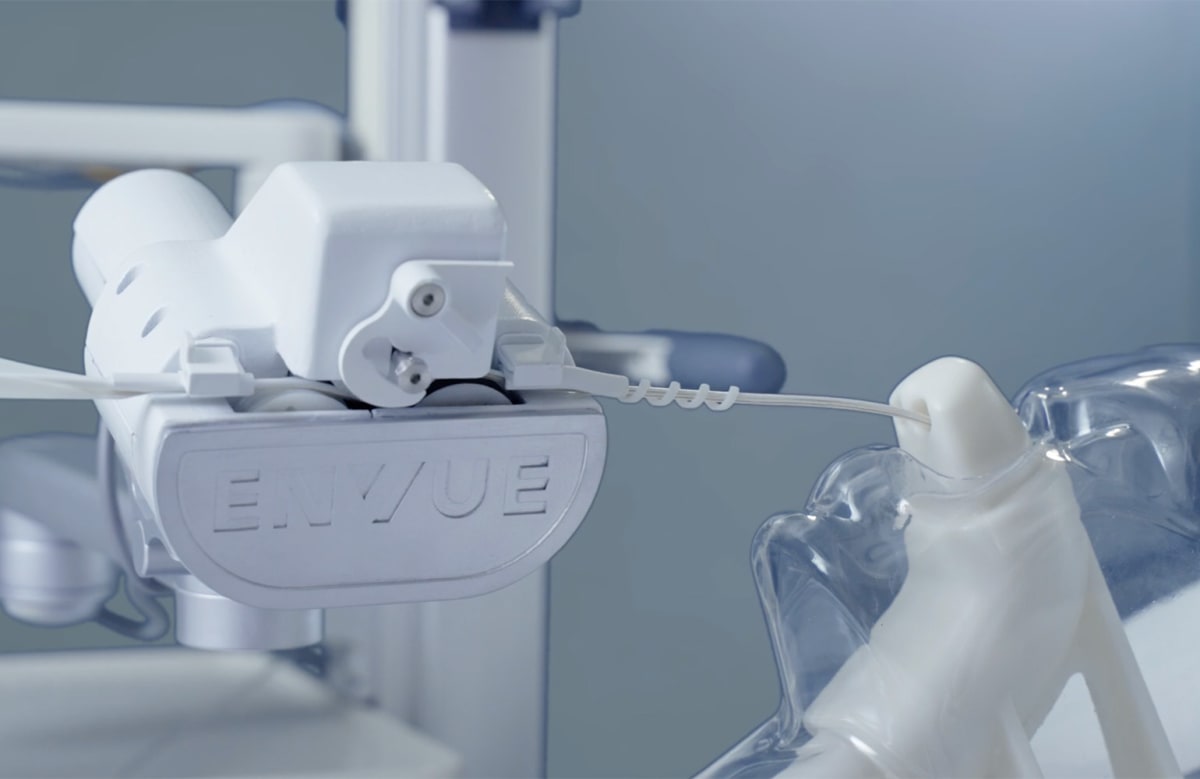 Robotic arm system inserting feeding tube into hospital patient under clinician supervision