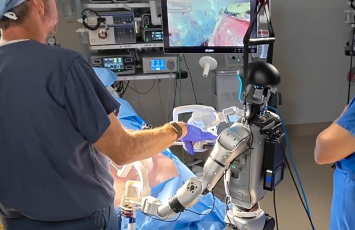 Humanoid robot performing surgical procedure alongside medical team in operating room at UC San Diego